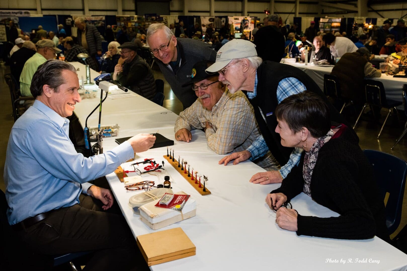 A group of people sitting at tables with food.