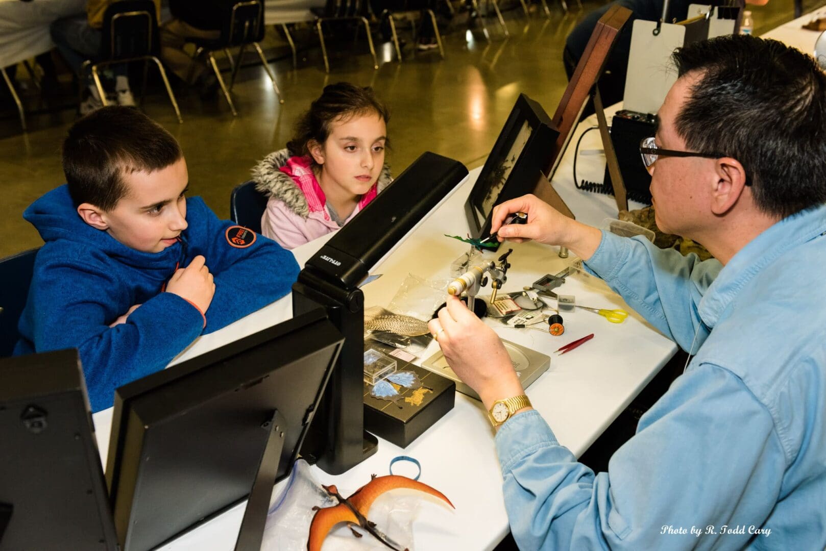 A man and two children sitting at a table.