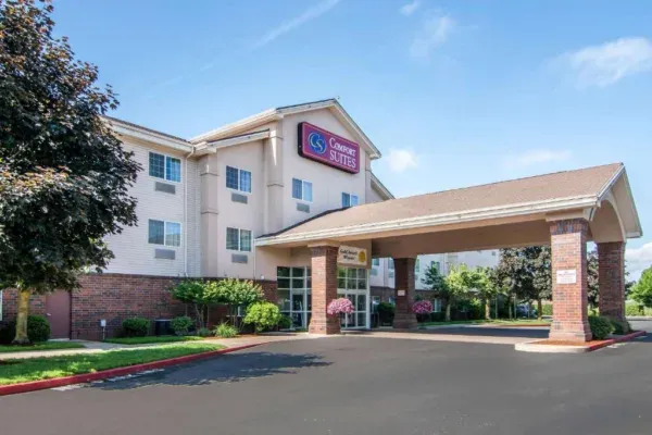 A hotel with a parking lot and a building