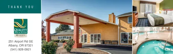 A large building with a covered entrance and bench.