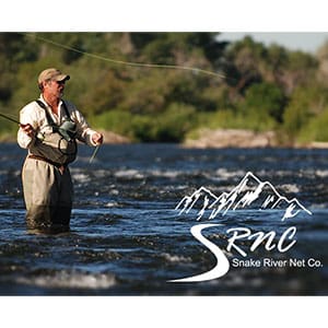 A man standing in the water holding onto a fishing rod.